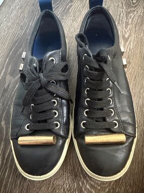Stuard Weitzman Black Leather Low-Top Sneakers with Gold Accent